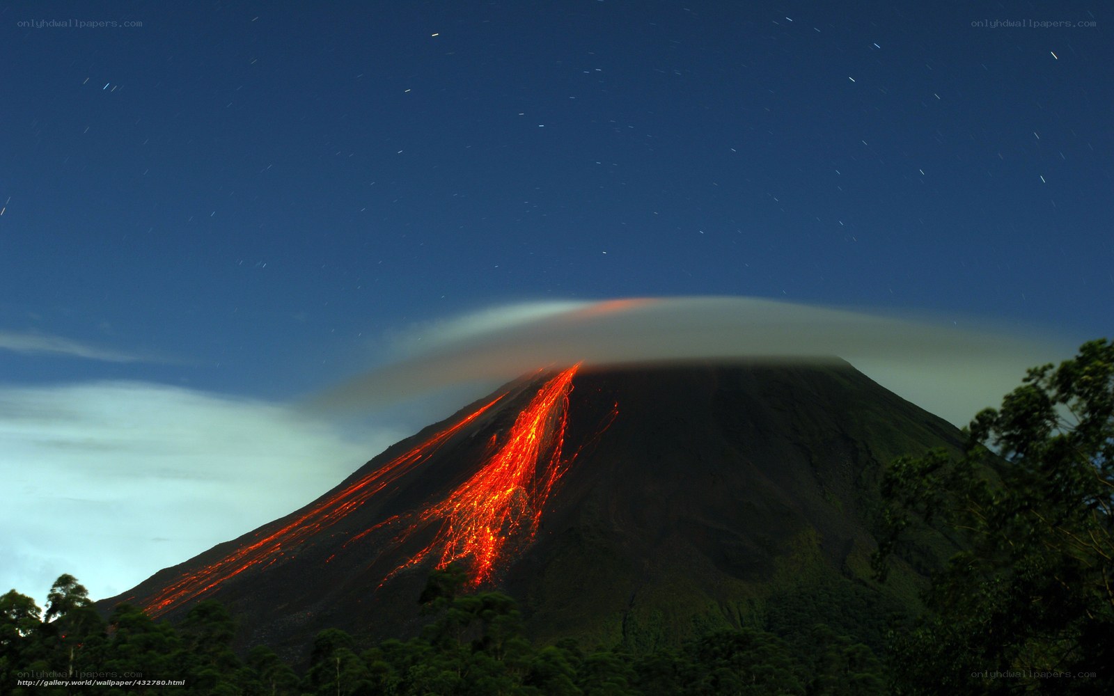 Volcano erupting at night