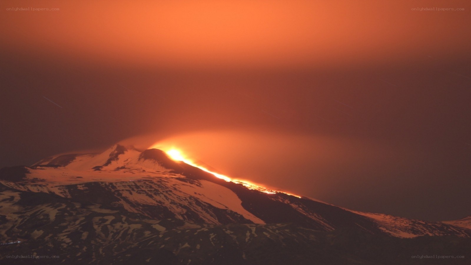 Volcano erupting at night