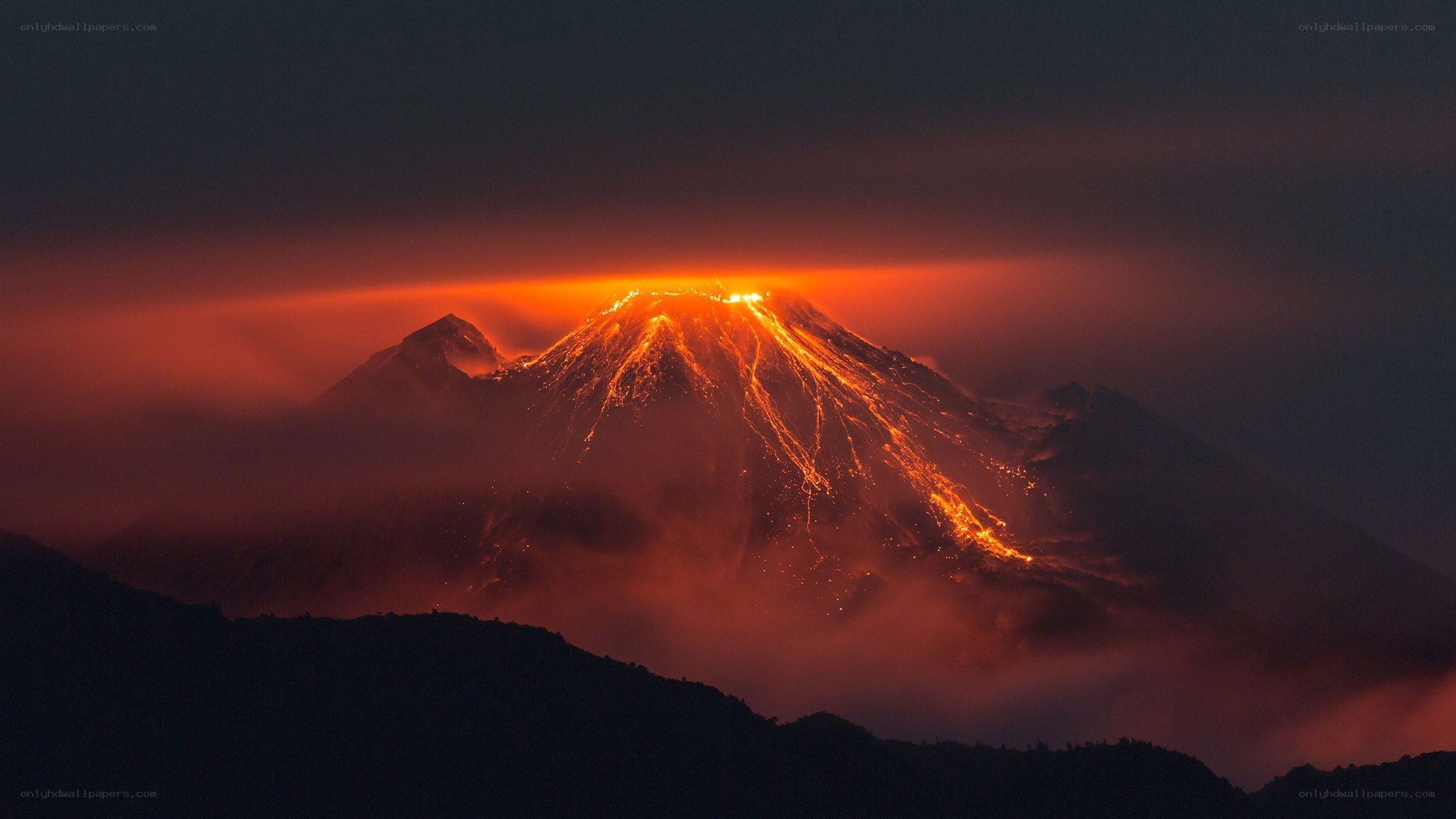 Volcano erupting at night