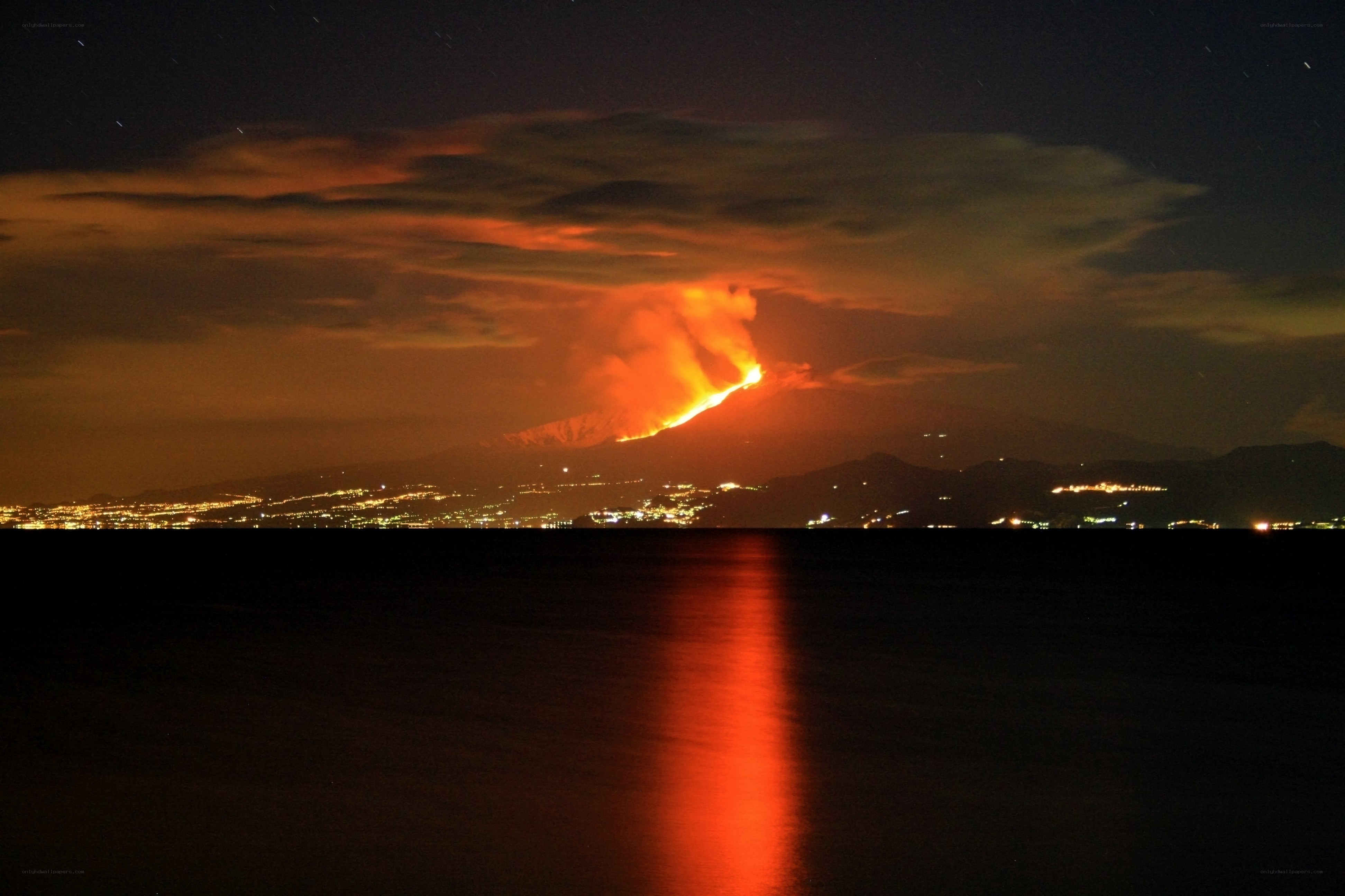 Volcano erupting at night