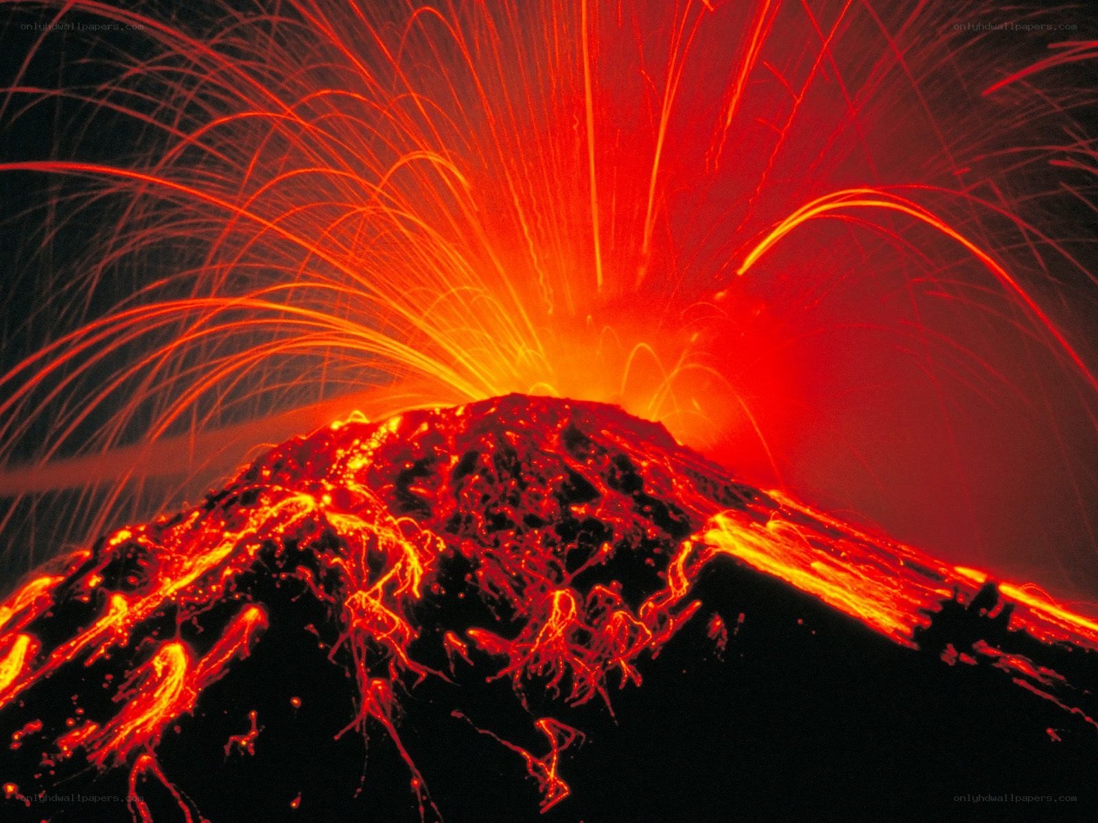 Volcano erupting at night