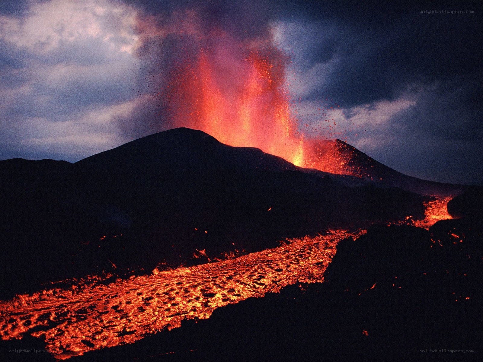 Volcano erupting at night