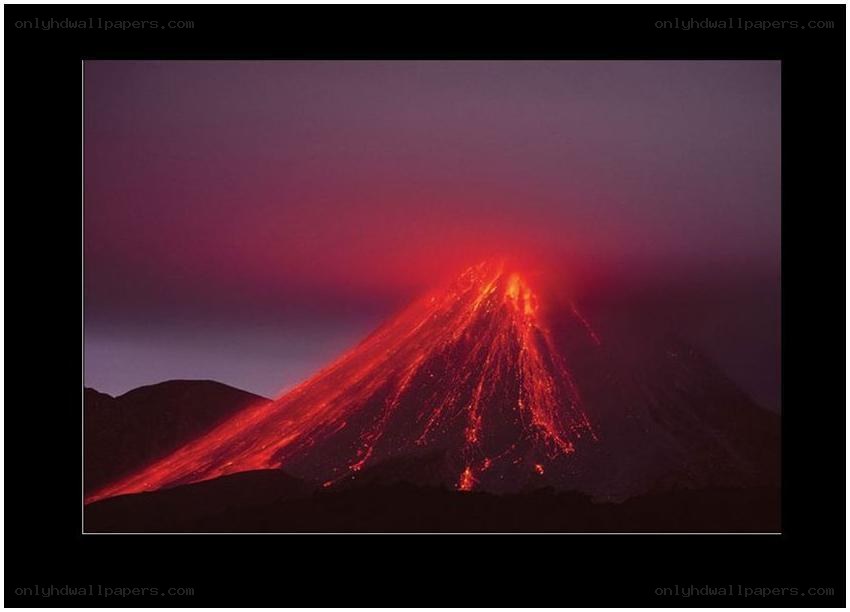 Volcano erupting at night