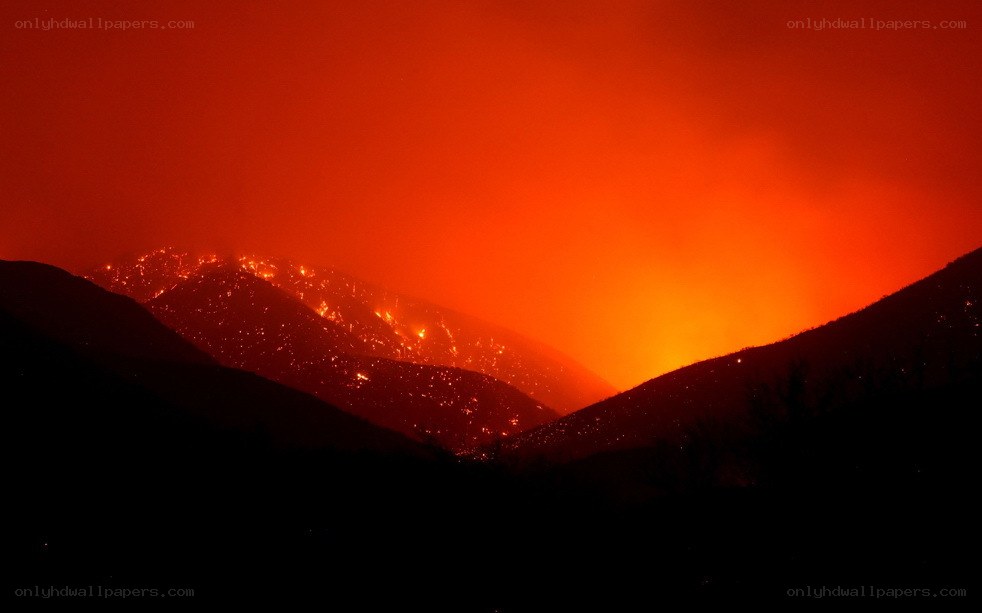 Volcano erupting at night
