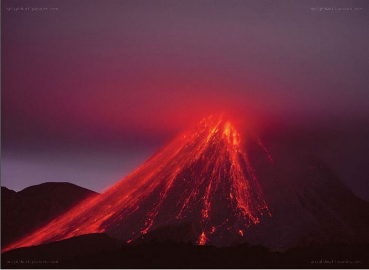 Volcano erupting at night