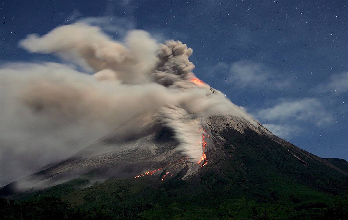 Volcano erupting at night