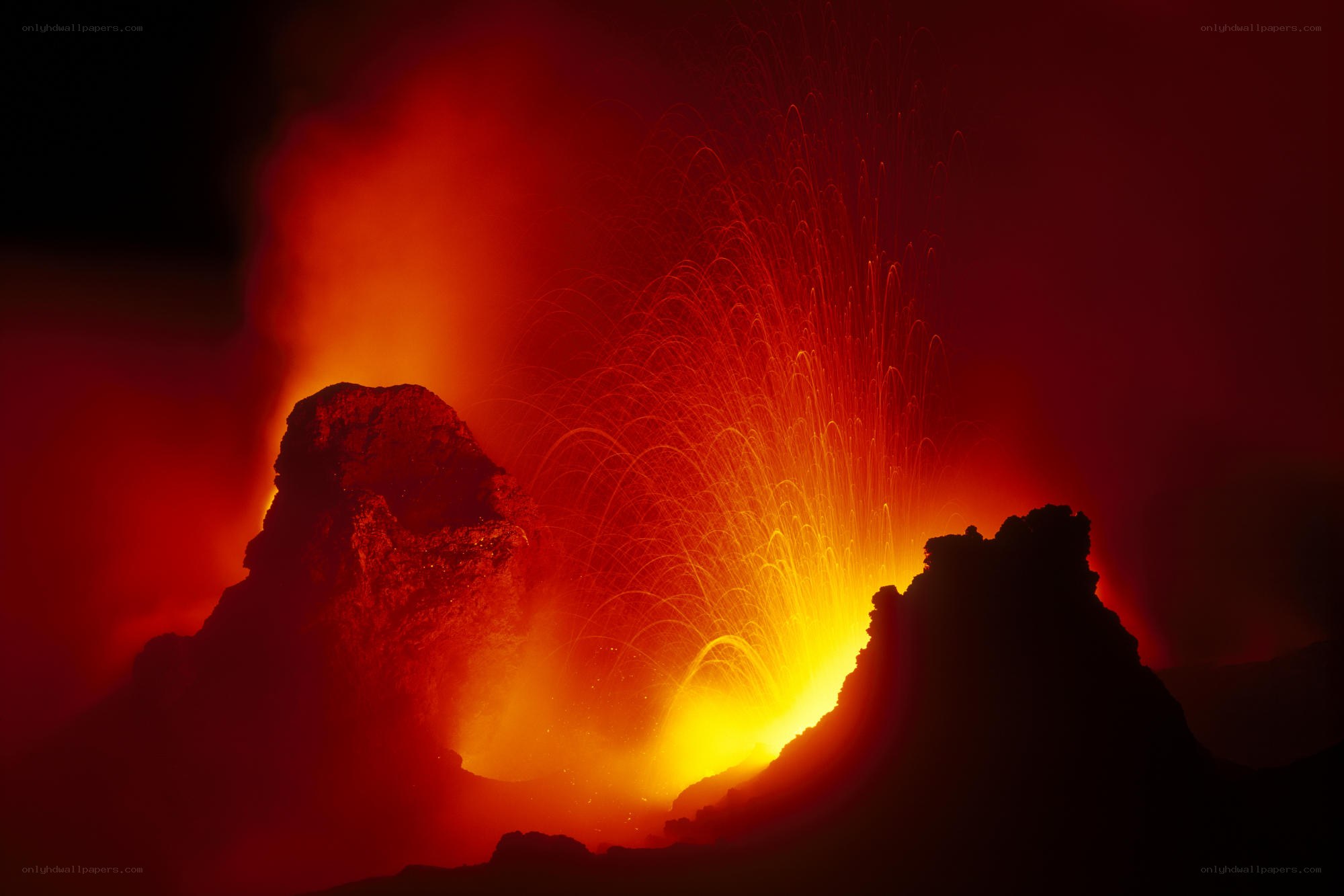Volcano erupting at night