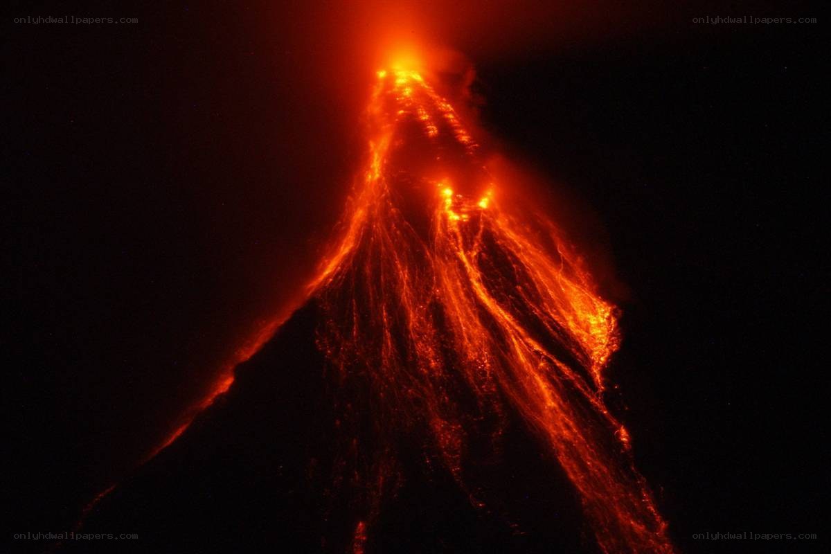 Volcano erupting at night