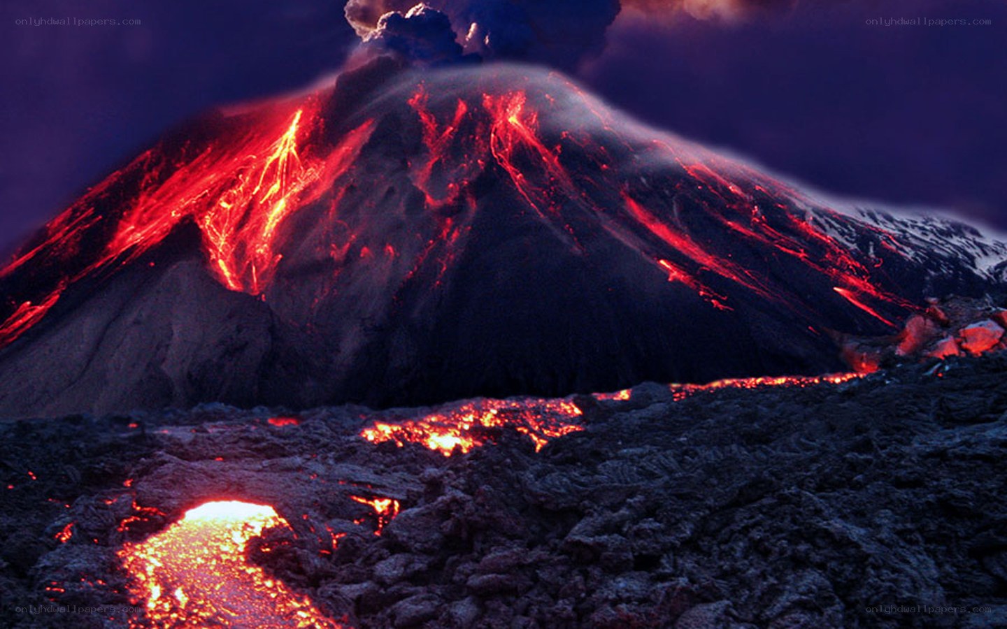 Volcano erupting at night