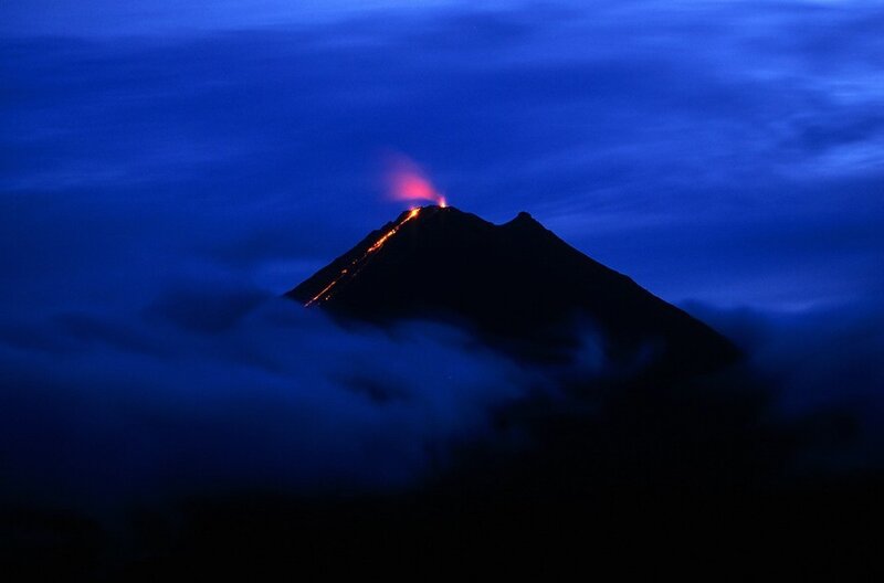 Volcano erupting at night