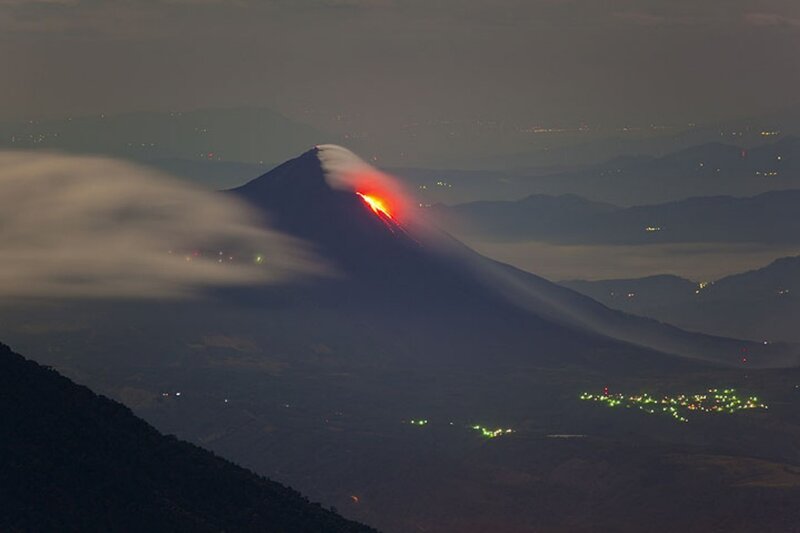 Volcano erupting at night