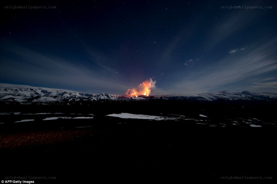 Volcano erupting at night