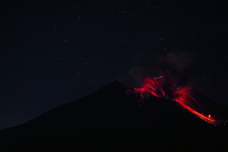 Volcano Erupting at Night — Black, Dramatic, Photograph, Lava, Stars
