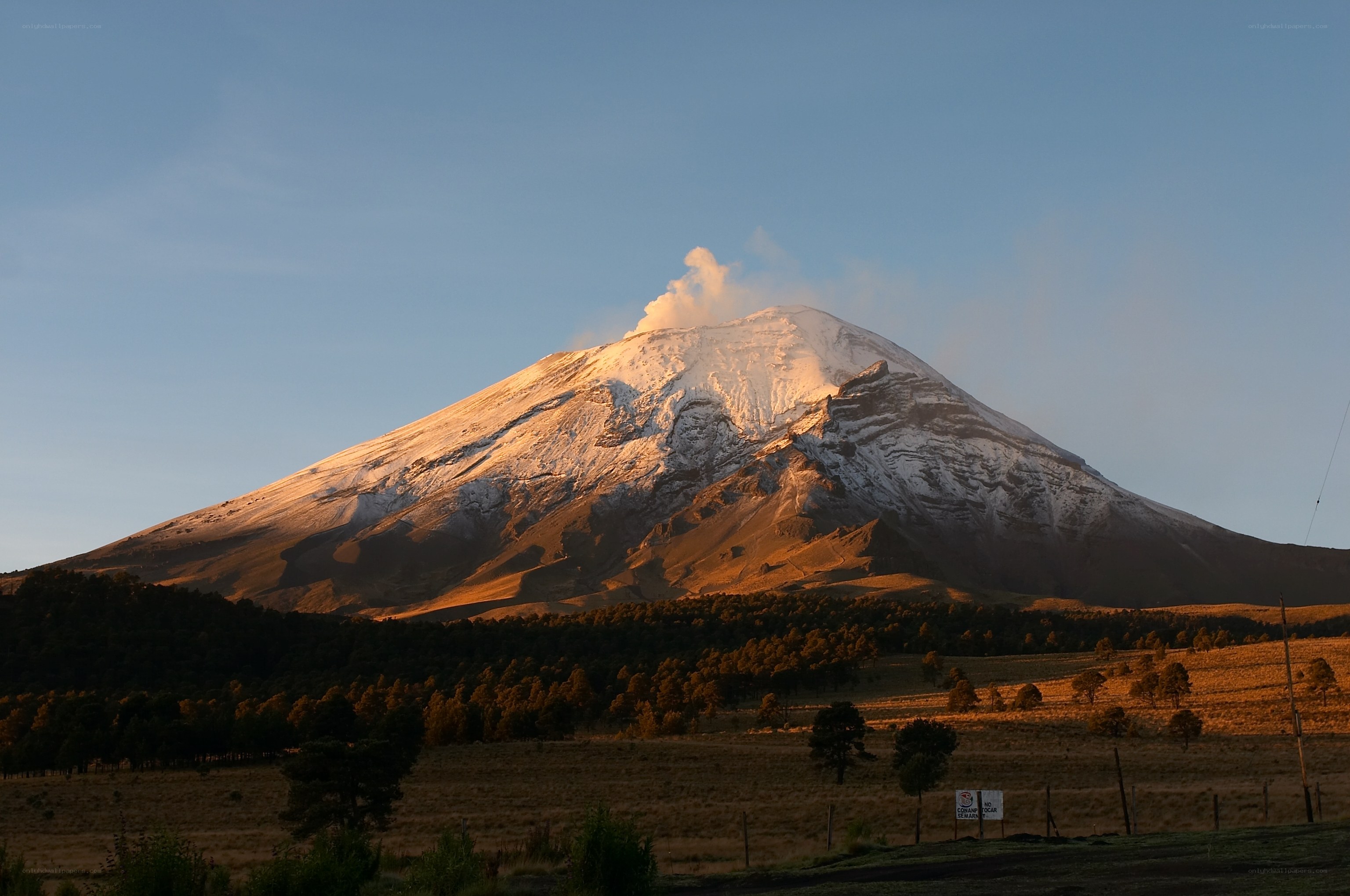 Volcano erupting at sunrise