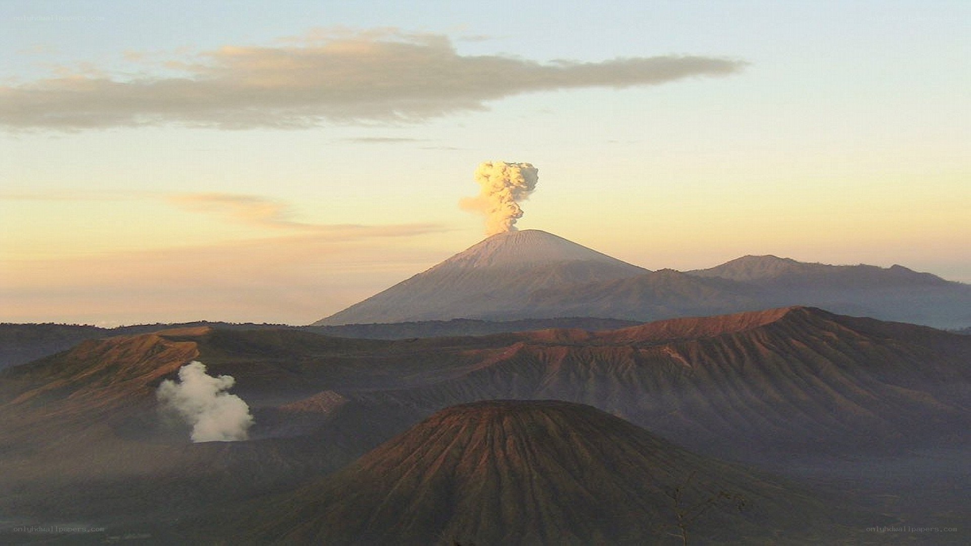 Volcano erupting at sunrise