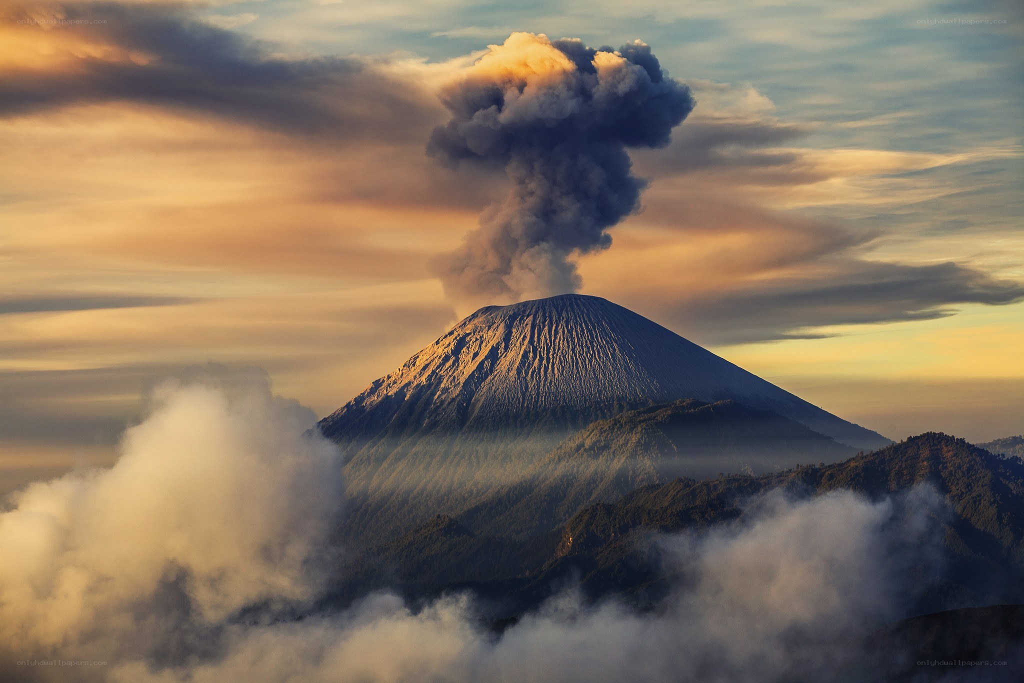 Volcano erupting at sunrise