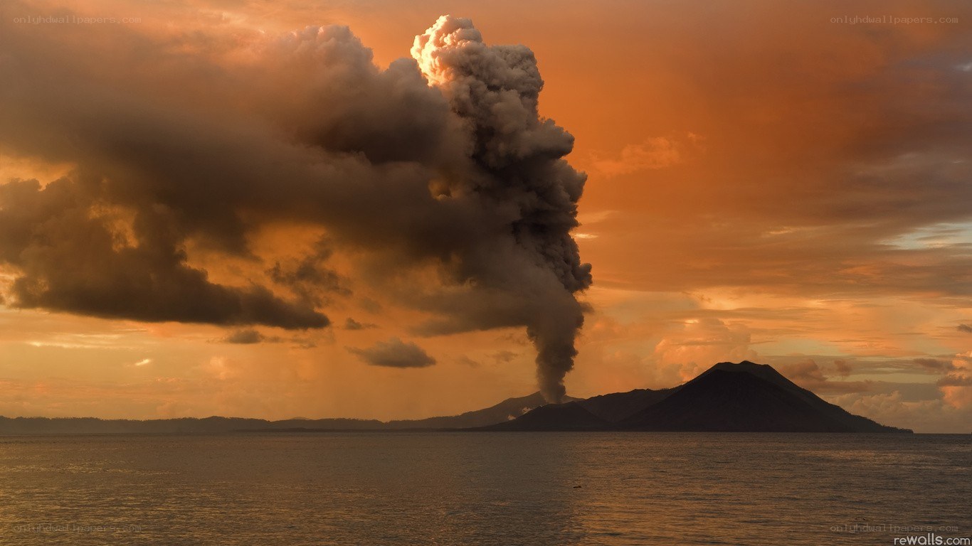 Volcano erupting at sunset