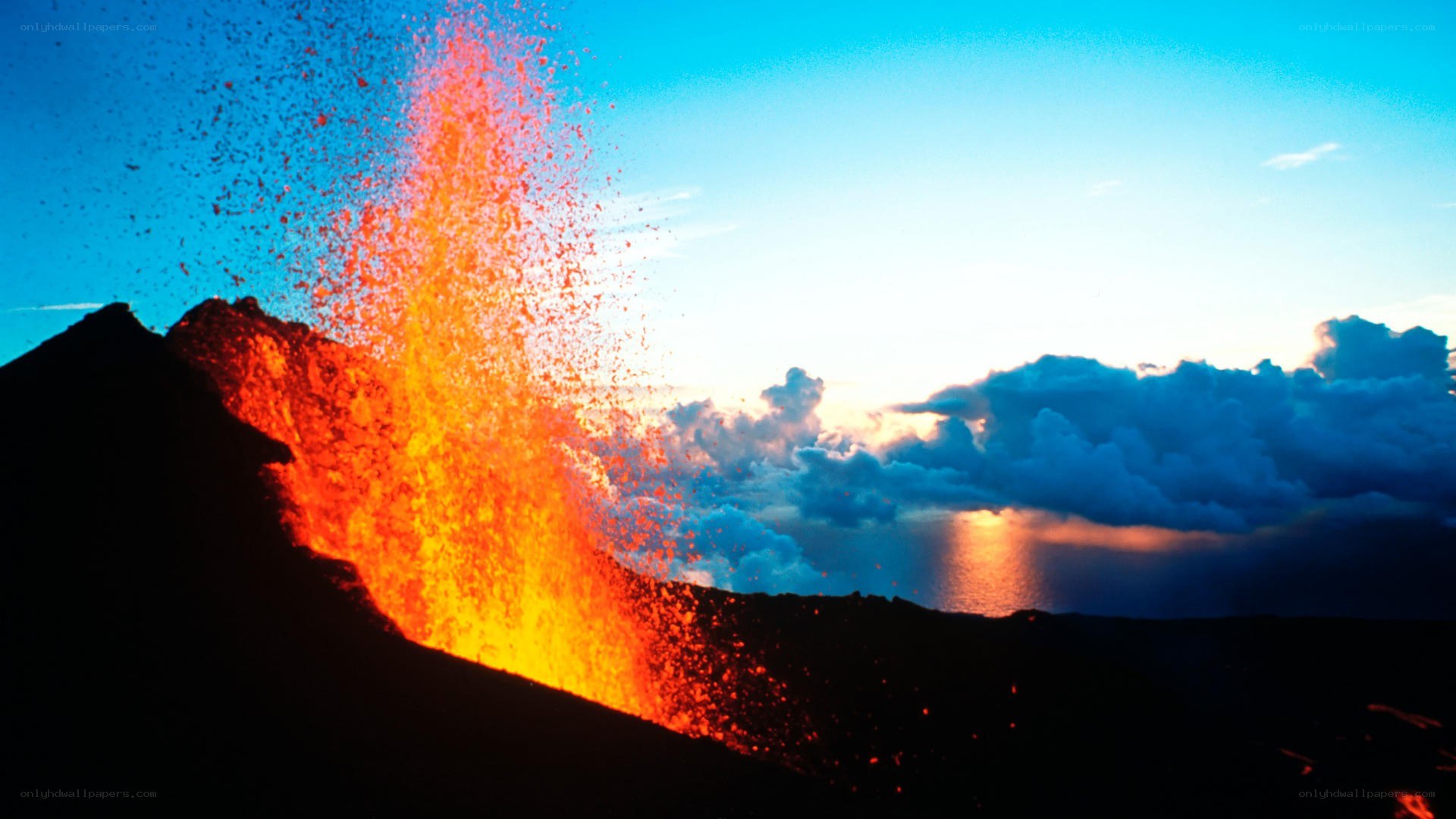 Volcano erupting at sunset