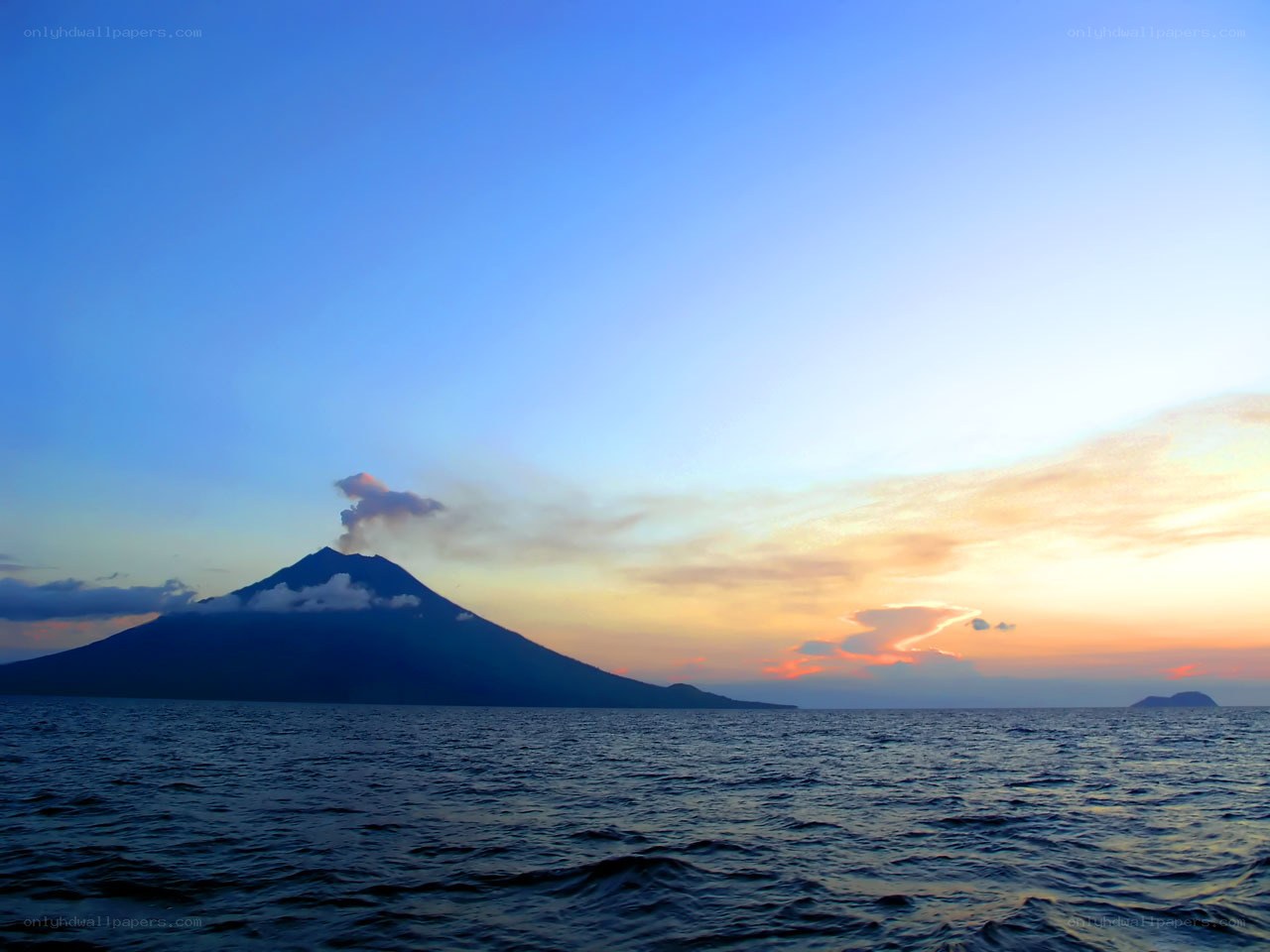 Volcano erupting at sunset