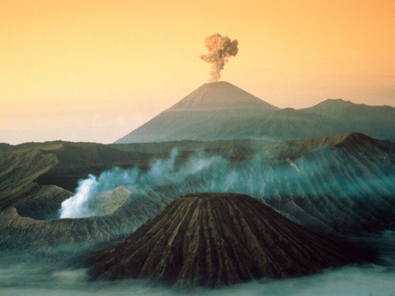 Volcano erupting at sunset