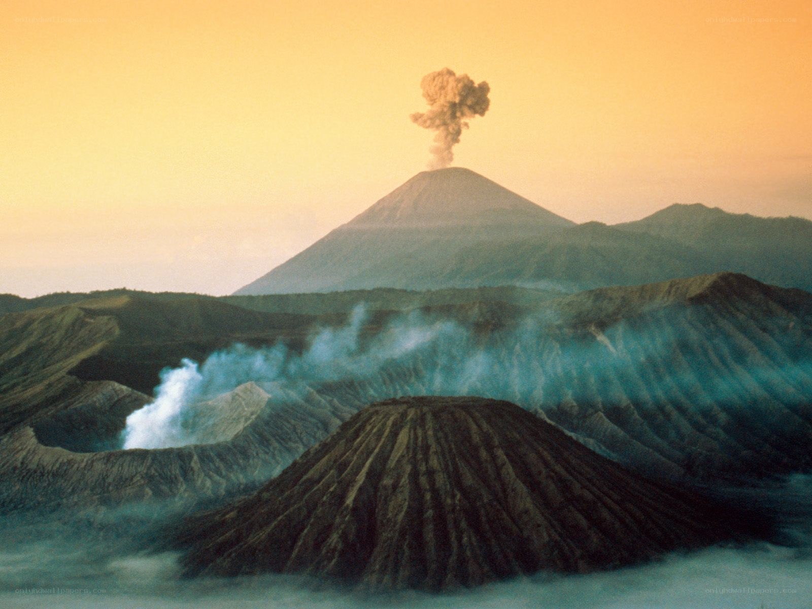 Volcano erupting at sunset
