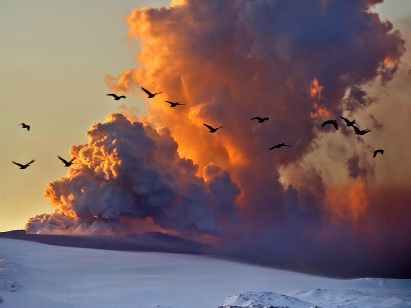 Volcano erupting at sunset