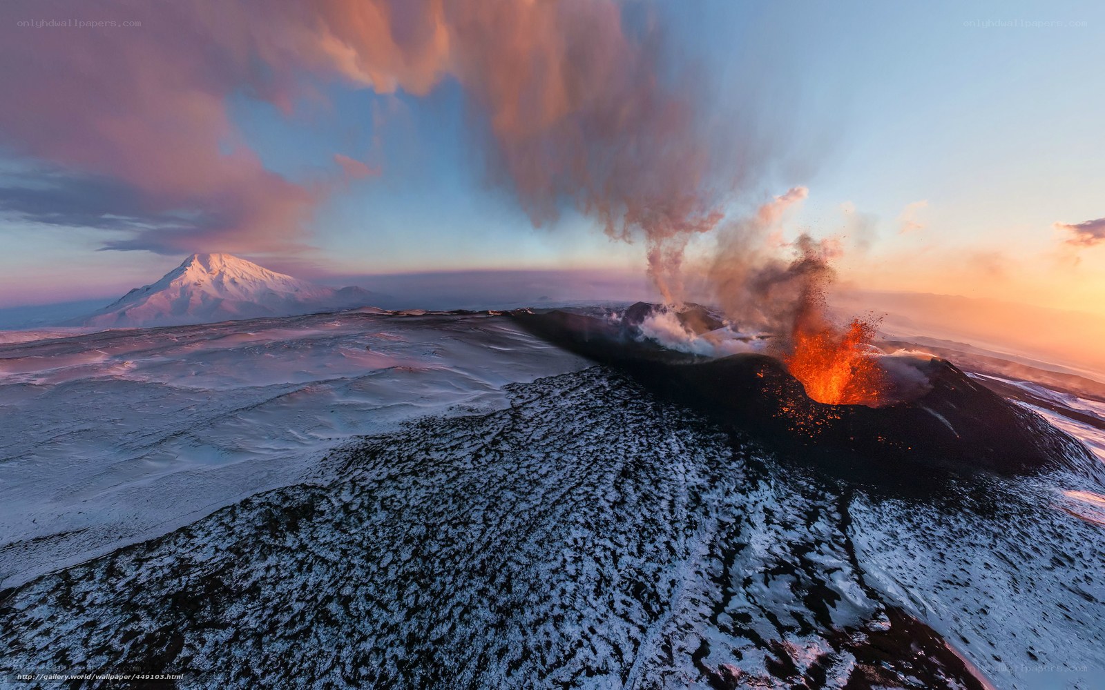 Volcano erupting at sunset