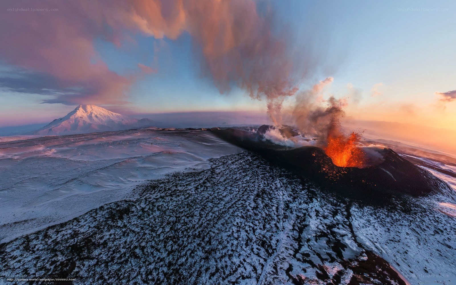 Volcano erupting at sunset