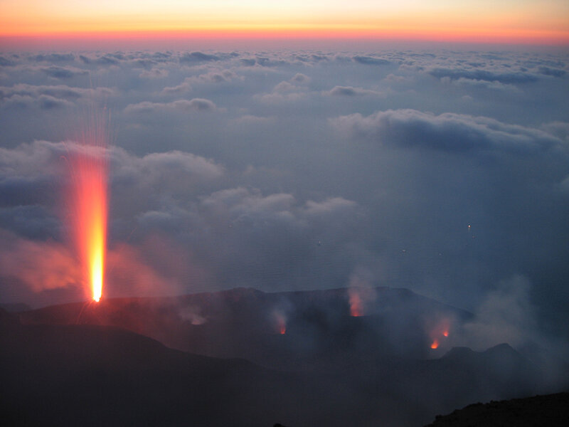 Volcano erupting at sunset