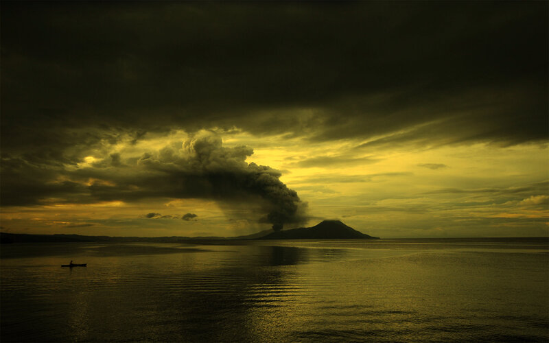Volcano erupting at sunset