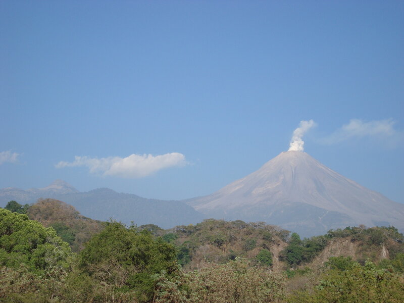volcano erupting in clear sky