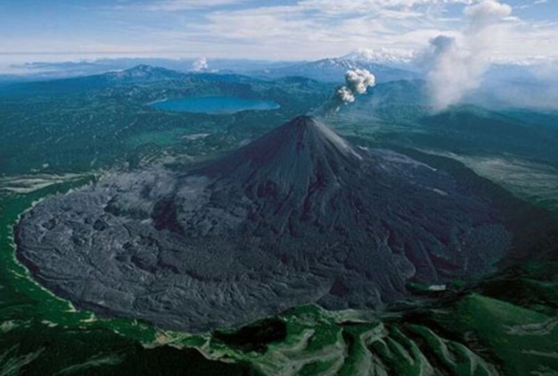 volcano erupting in landscape