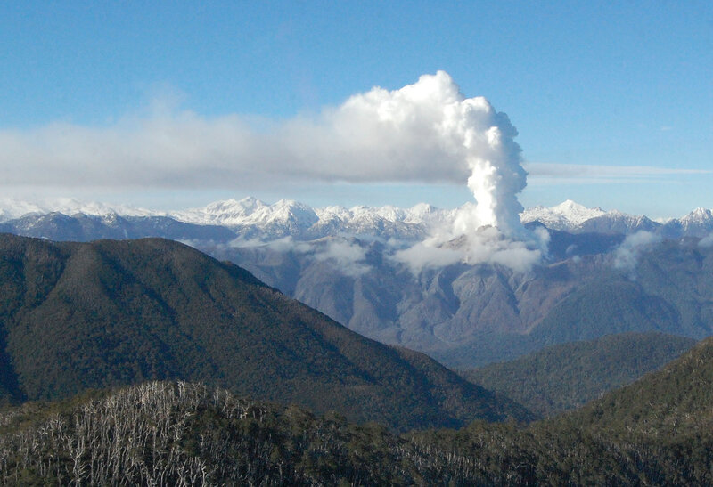 Volcano erupting in mountain range