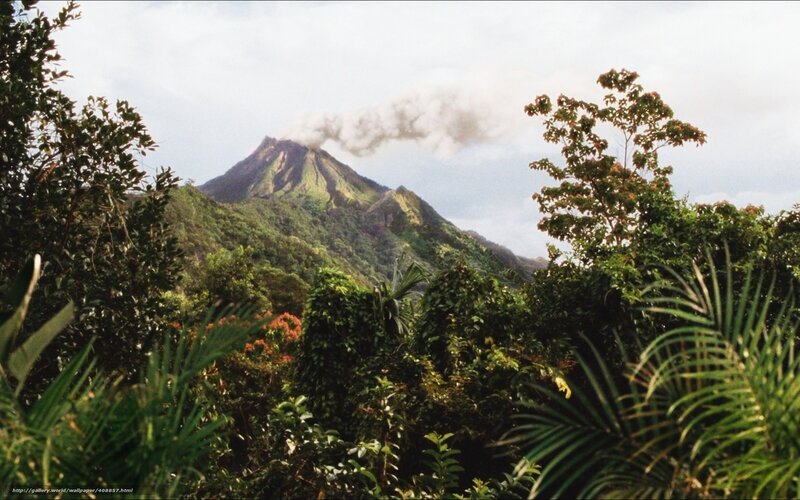volcano erupting in tropical forest