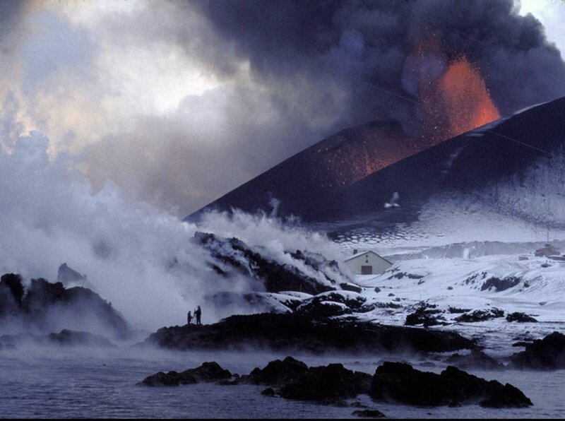 Volcano erupting near coastal village