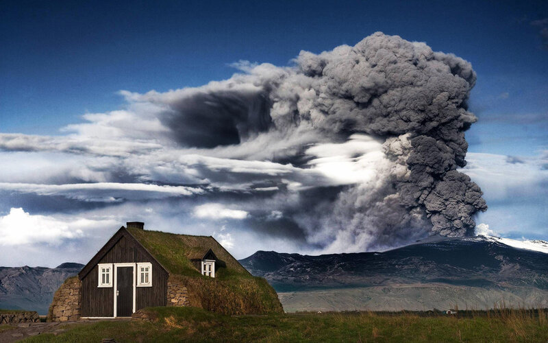 Volcano Erupting Near Cottage