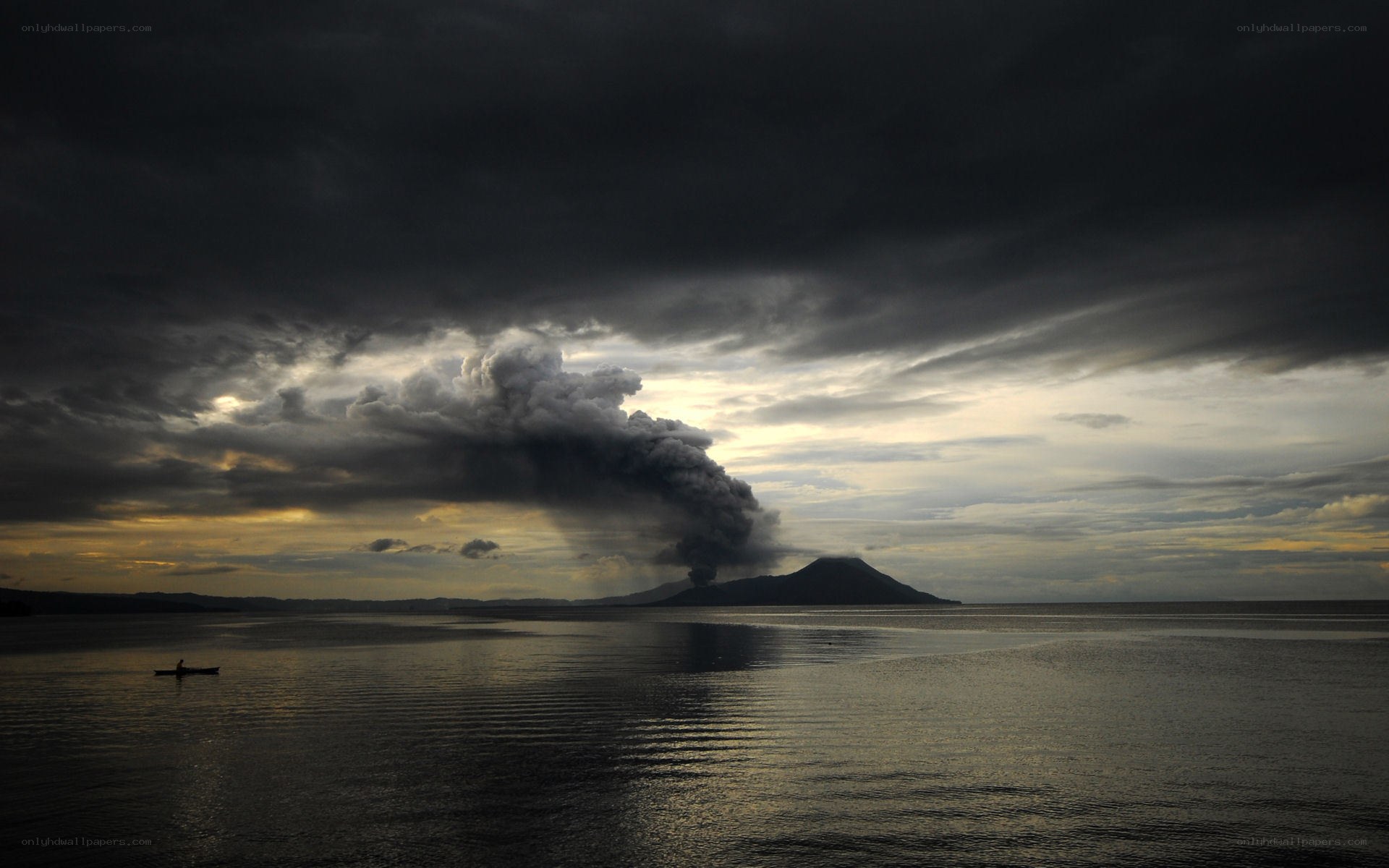 Volcano erupting over sea