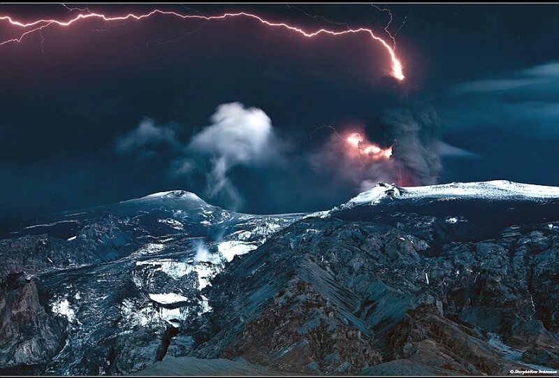 Volcano erupting under lightning storm