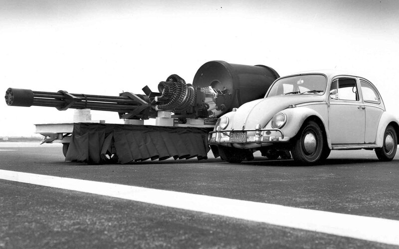 Volkswagen Beetle next to a cannon