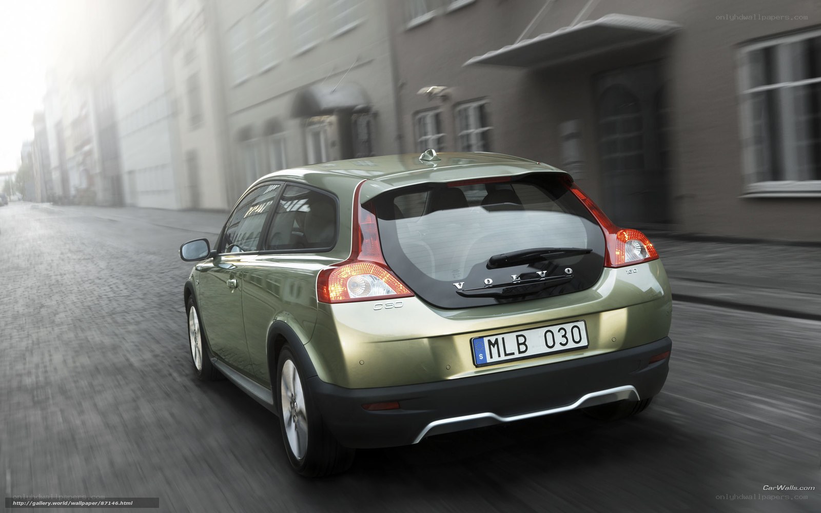 Volvo C30 driving on city street
