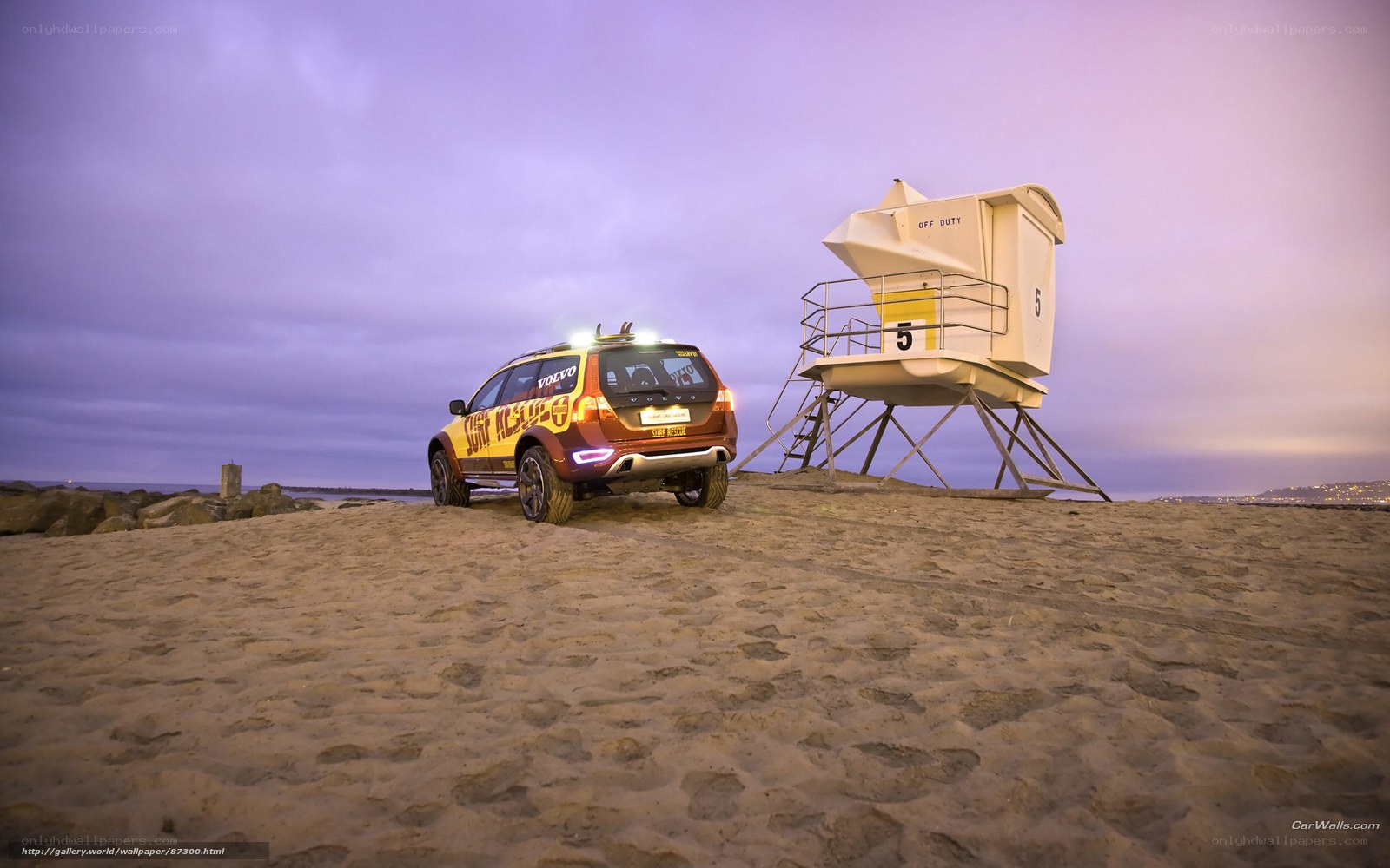 Volvo car on beach at dusk