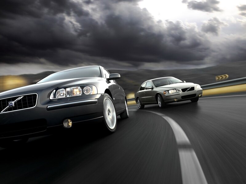 Volvo cars on a winding road