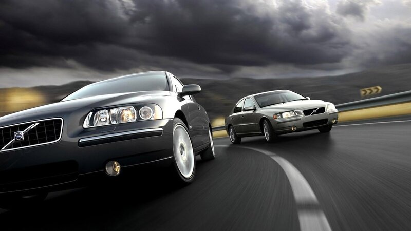Volvo cars on a winding road
