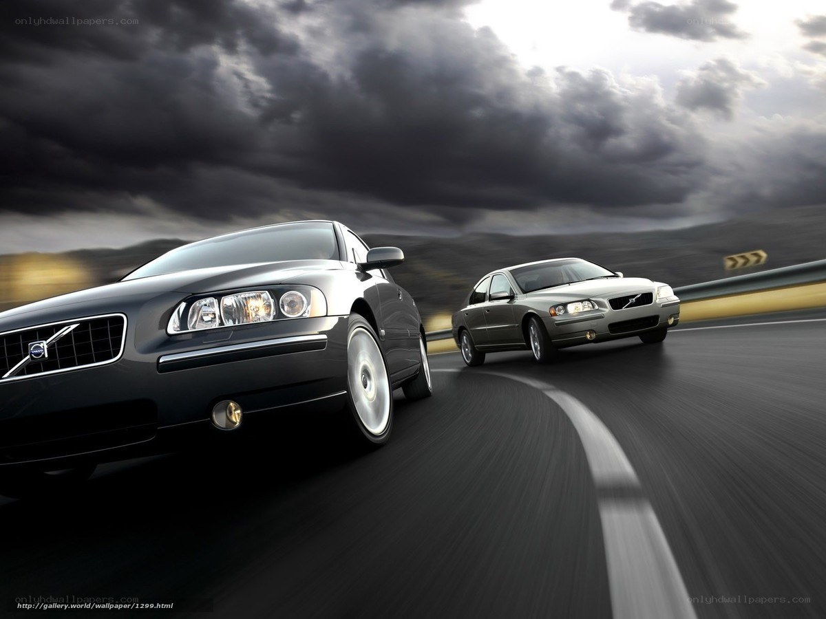 Volvo cars on a winding road