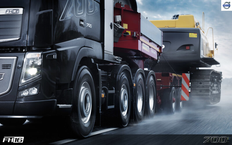 Volvo FH16 truck transporting heavy machinery