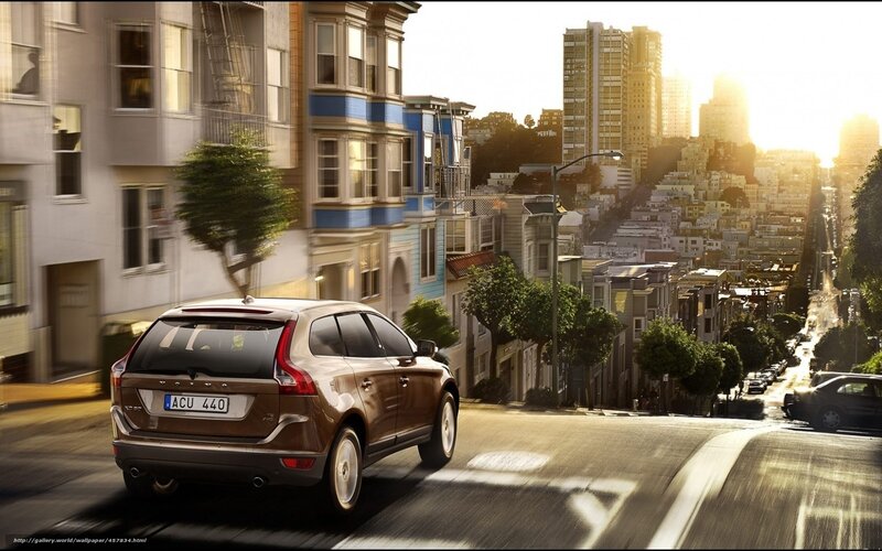 Volvo on a city street at sunset