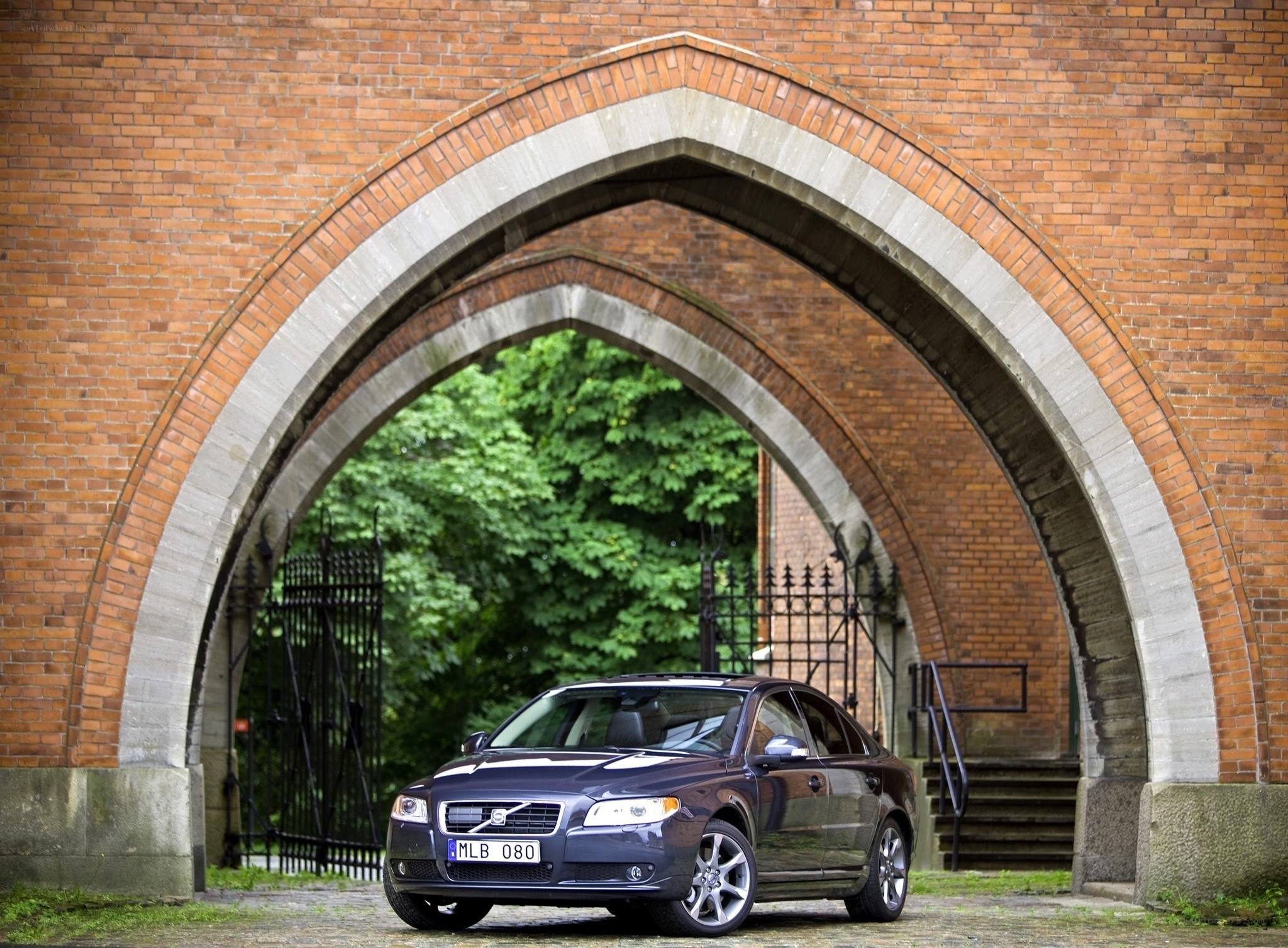 Volvo sedan under brick arch