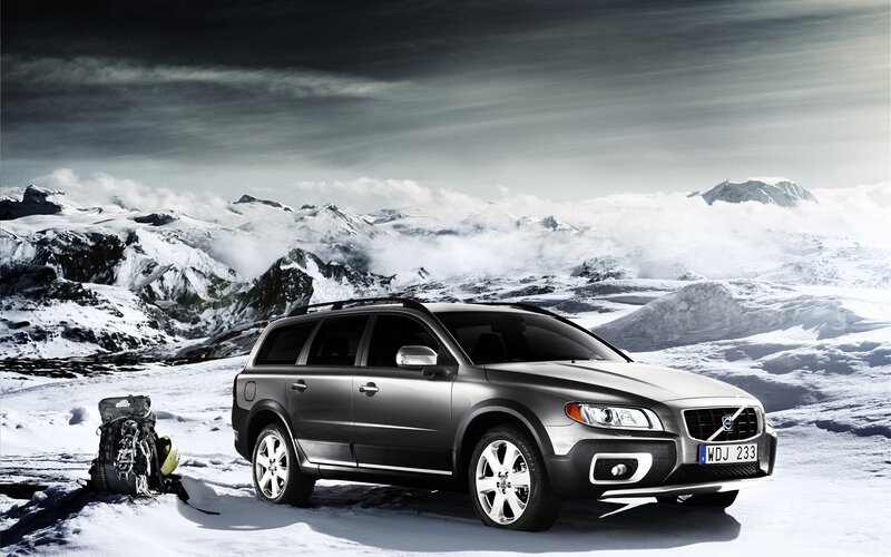 Volvo station wagon in snowy mountains