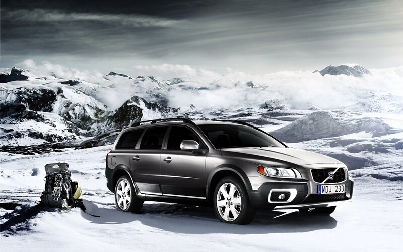 Volvo station wagon in snowy mountains