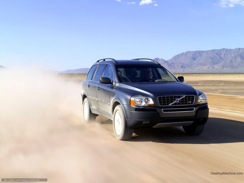 Volvo SUV driving on desert road